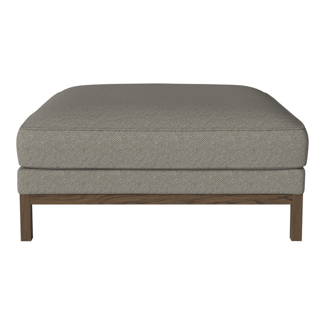 Gray upholstered ottoman with a smooth texture and wooden legs, offering a minimalist and modern design.
