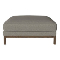 Gray upholstered ottoman with a smooth texture and wooden legs, offering a minimalist and modern design.