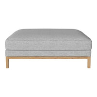 Light gray fabric ottoman with subtle texture and natural wood base, perfect for modern living spaces.