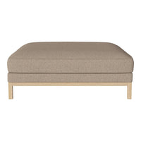 Beige upholstered ottoman with textured fabric and natural wood legs. Clean, minimalist design enhances any decor.