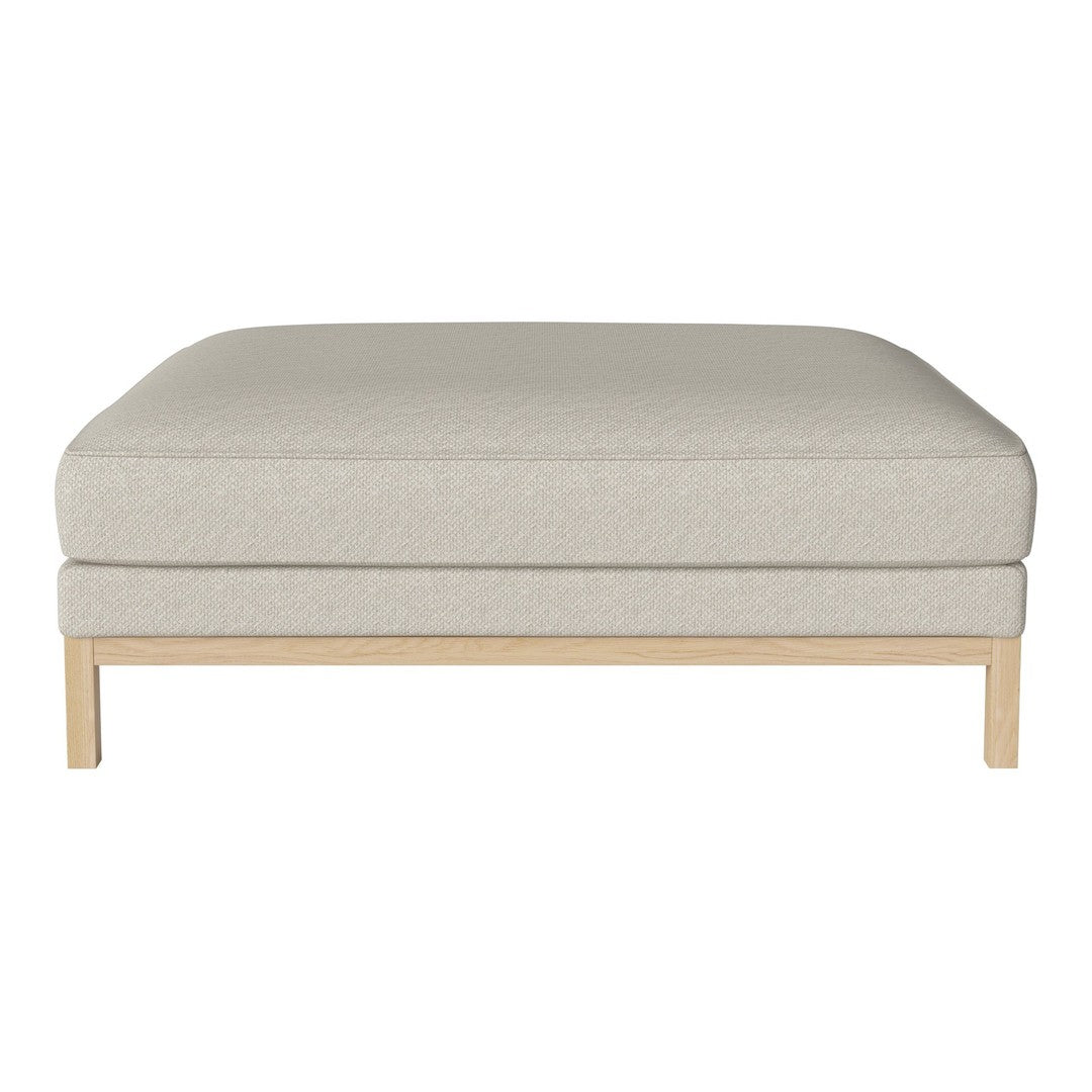 Light beige ottoman with a textured fabric and simple wooden base. Modern, minimalist style for versatile decor.