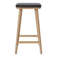 Black upholstered stool with natural wood legs and a smooth, simple design. Perfect for modern spaces.