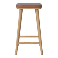 Brown padded stool with a natural wood frame, featuring a minimalist design and smooth finishes. Perfect for any setting.