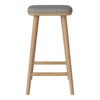 Gray upholstered stool with natural wood legs, featuring a sleek, minimalist design. Ideal for modern spaces.
