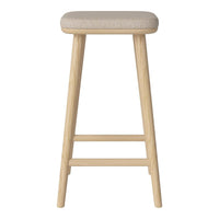 Beige cushioned seat on natural wood legs, featuring a minimalist design with smooth textures and subtle tones.