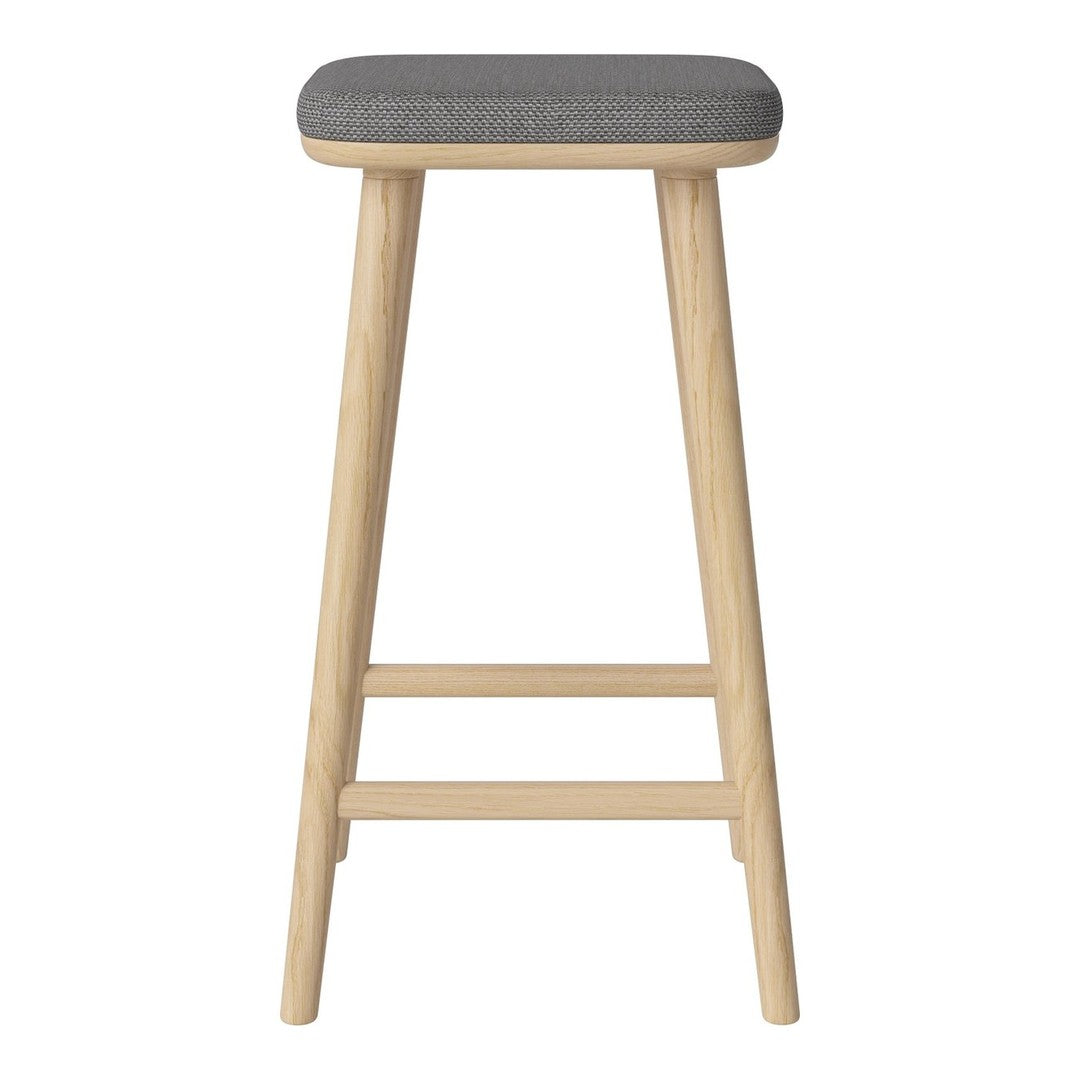 Wooden bar stool with natural finish and gray upholstered seat. Minimalist design, sleek lines, and neutral color palette.