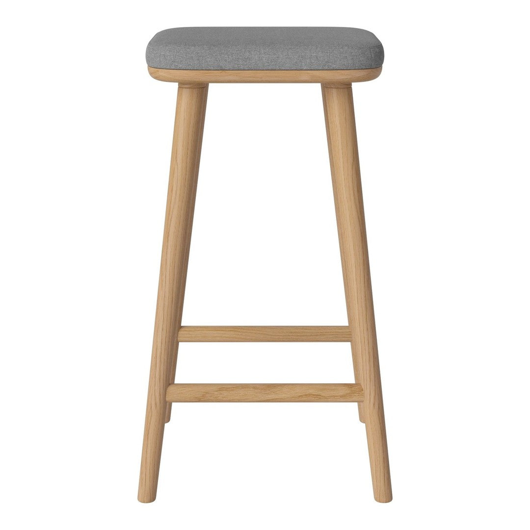 Gray upholstered stool with natural wood legs, featuring a smooth finish and minimalist design. Perfect for modern decor.
