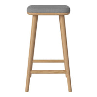 Gray upholstered stool with natural wood legs, featuring a smooth finish and minimalist design. Perfect for modern decor.