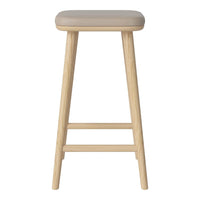 Light beige padded stool with natural wood legs, featuring a sleek, minimalist design. Ideal for modern decor.