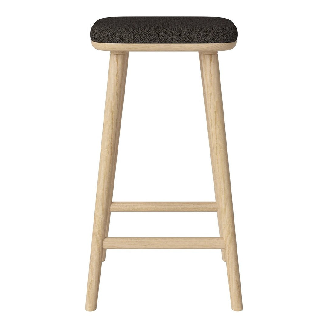 Black upholstered stool with natural wood legs, featuring a minimalist design and clean lines. Ideal for modern decor.