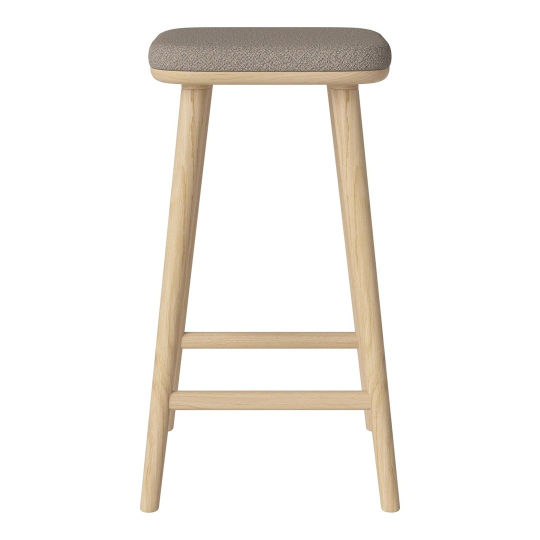 Light wood bar stool with a soft, gray upholstered seat, featuring a minimalistic and modern design.
