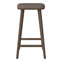 Brown upholstered stool with a textured seat and sleek, dark wooden legs. Ideal for modern or rustic decor.