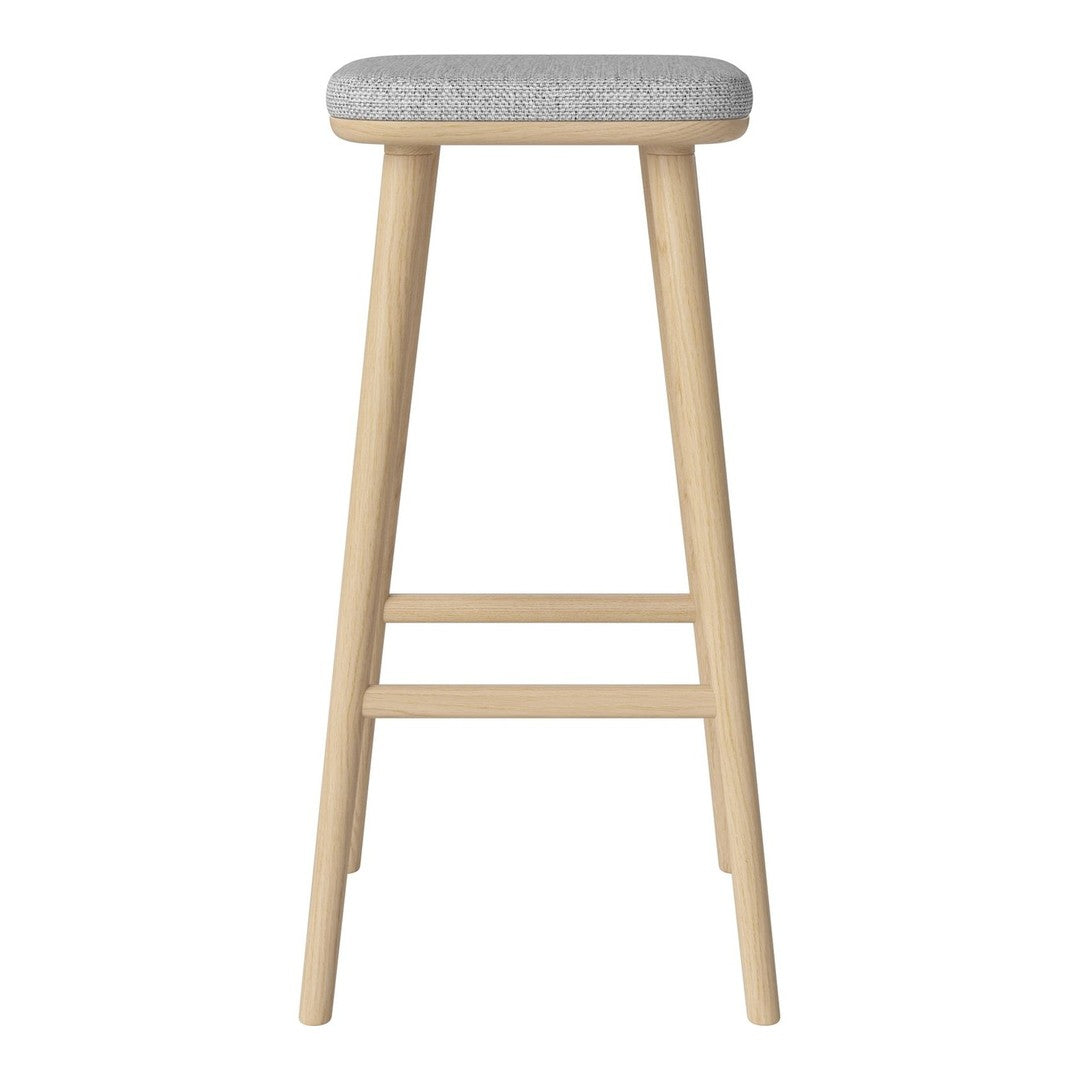 Light wood barstool with a soft gray upholstered seat. Minimalist, modern design with a clean finish.