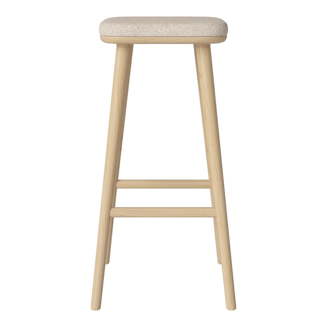 Light natural wood bar stool with a soft, cream upholstered seat. Simple and modern design without patterns.