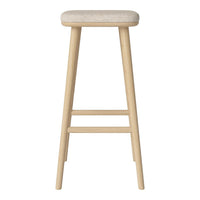 Light natural wood bar stool with a soft, cream upholstered seat. Simple and modern design without patterns.