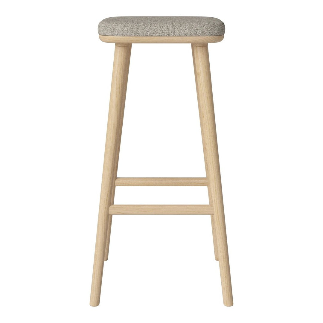 Light wooden bar stool with a soft gray upholstered seat, featuring a simple and modern design.