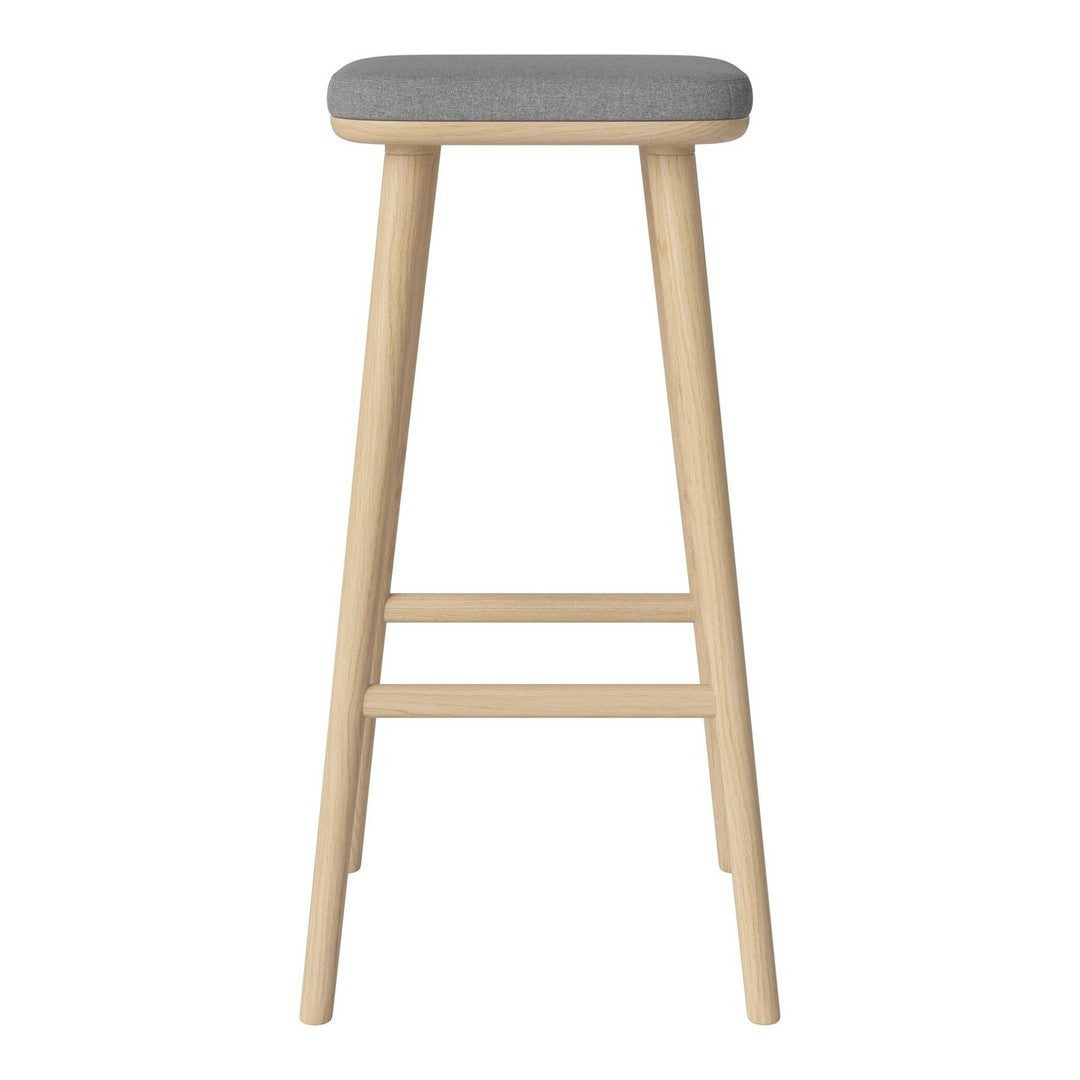 Light wood bar stool with a sleek grey upholstered seat, perfect for modern decor.
