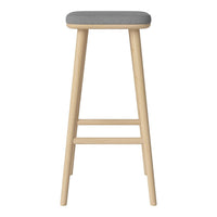 Light wood bar stool with a sleek grey upholstered seat, perfect for modern decor.