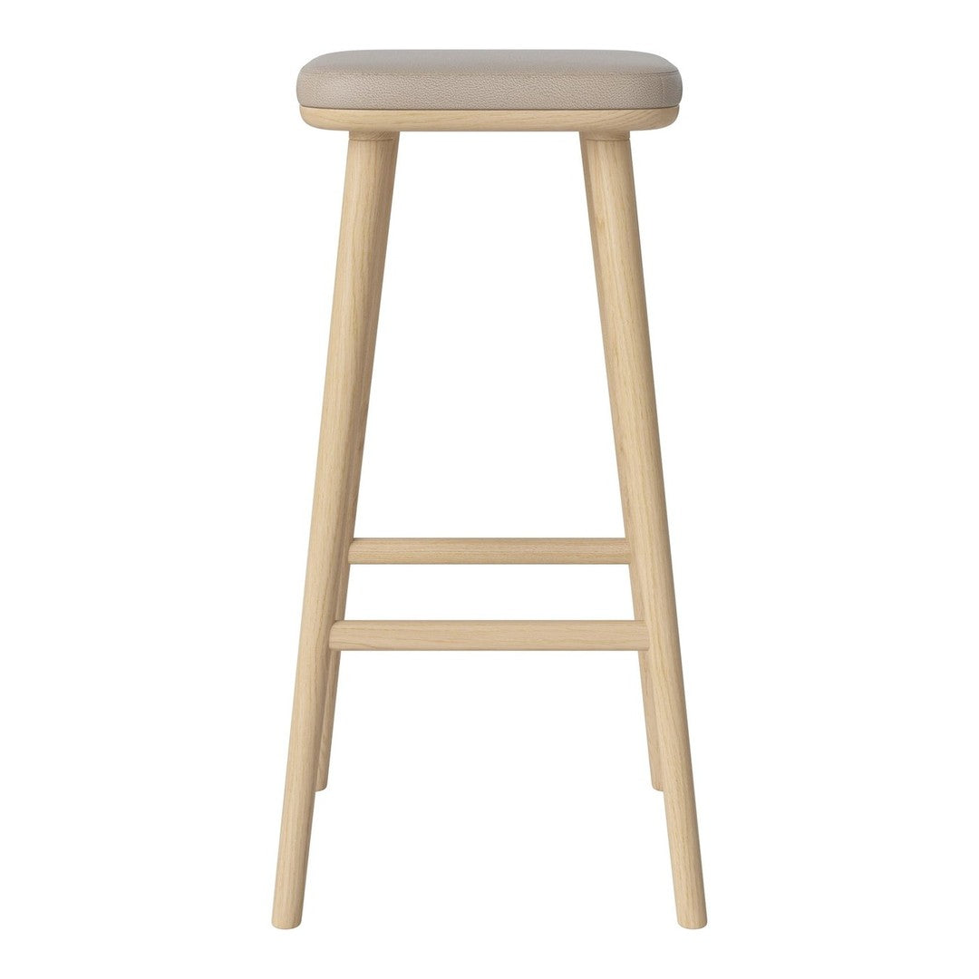 Light beige upholstered seat on a natural wooden bar stool with clean lines and a minimalist design.
