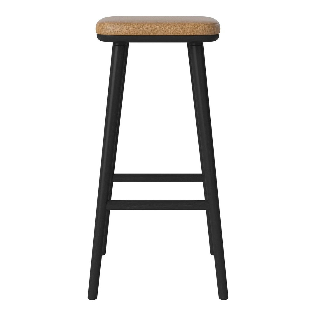 Black wooden bar stool with a smooth tan seat, showcasing a minimalist design and contrasting color palette.