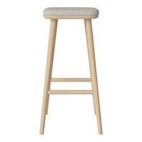 Light wood bar stool with a soft, neutral gray cushion. Stylish and minimalist design with clean lines.