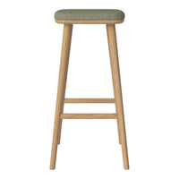 Green patterned upholstery on a natural wood bar stool with a sleek, minimalist design.