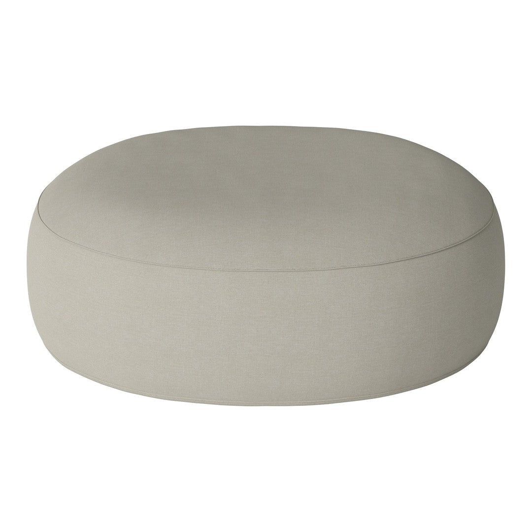 Round beige pouf with a smooth, solid texture, perfect for modern home decor. Ideal for versatile styling options.