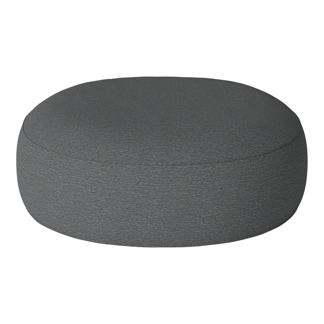 Round grey pouf with a textured finish, perfect for modern decor. Versatile and stylish accent piece for any space.