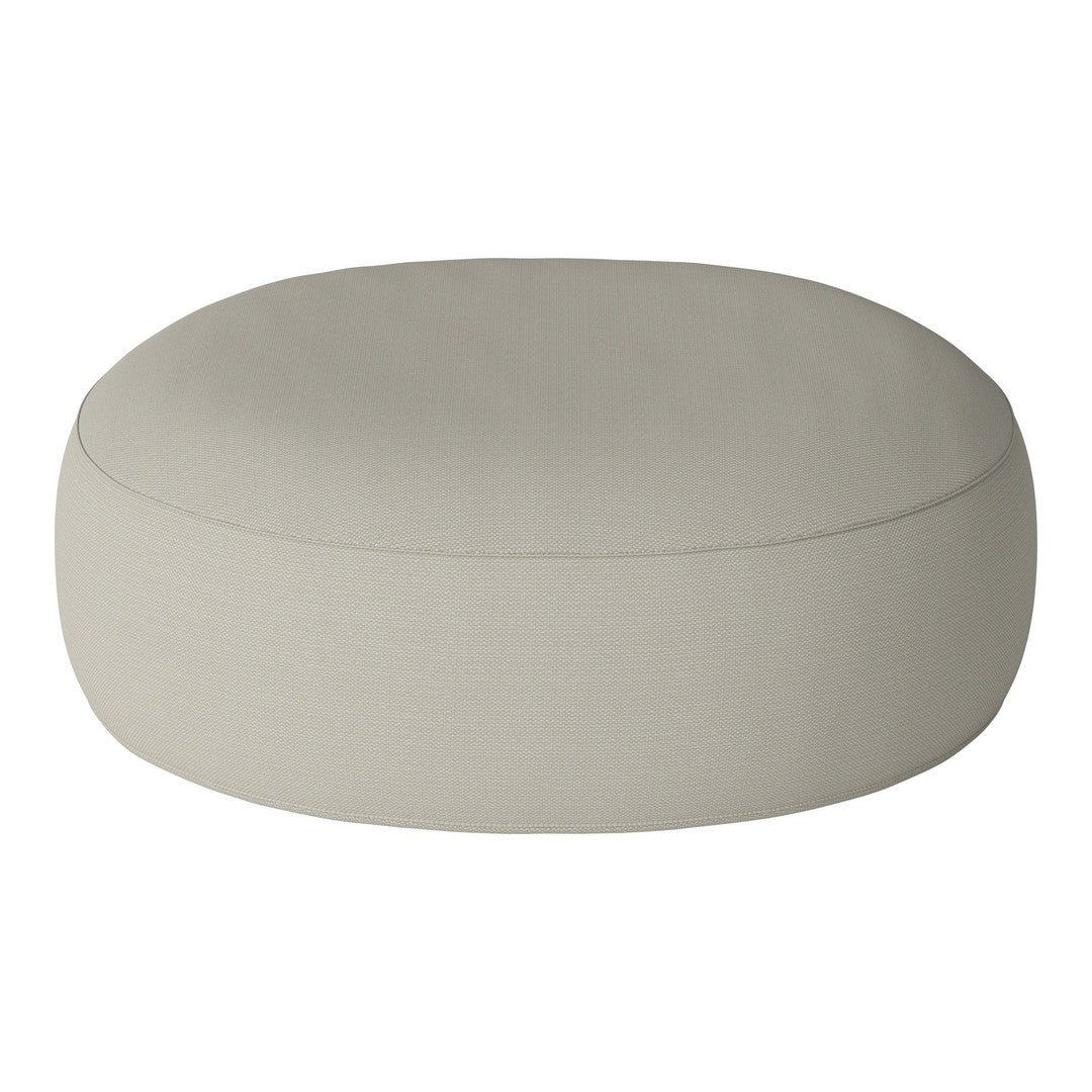 Light beige round pouf with a smooth, muted surface texture, perfect for minimalist decor.