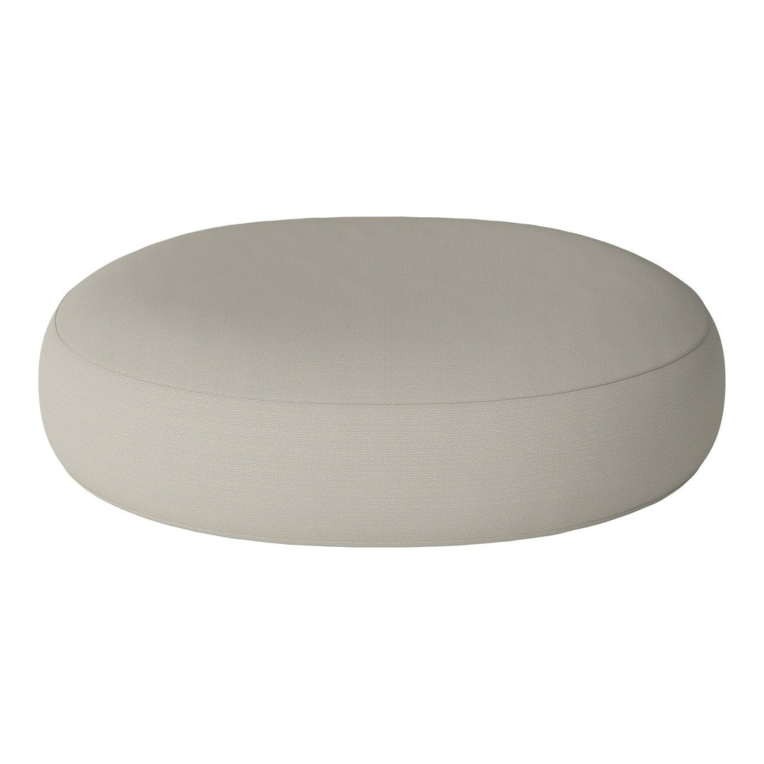 Round, soft ottoman in a light beige color with a smooth, solid pattern, perfect for modern home decor.