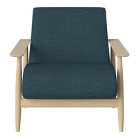 Teal textured upholstery on a modern chair with light wood arms, combining stylish colors and natural elements.