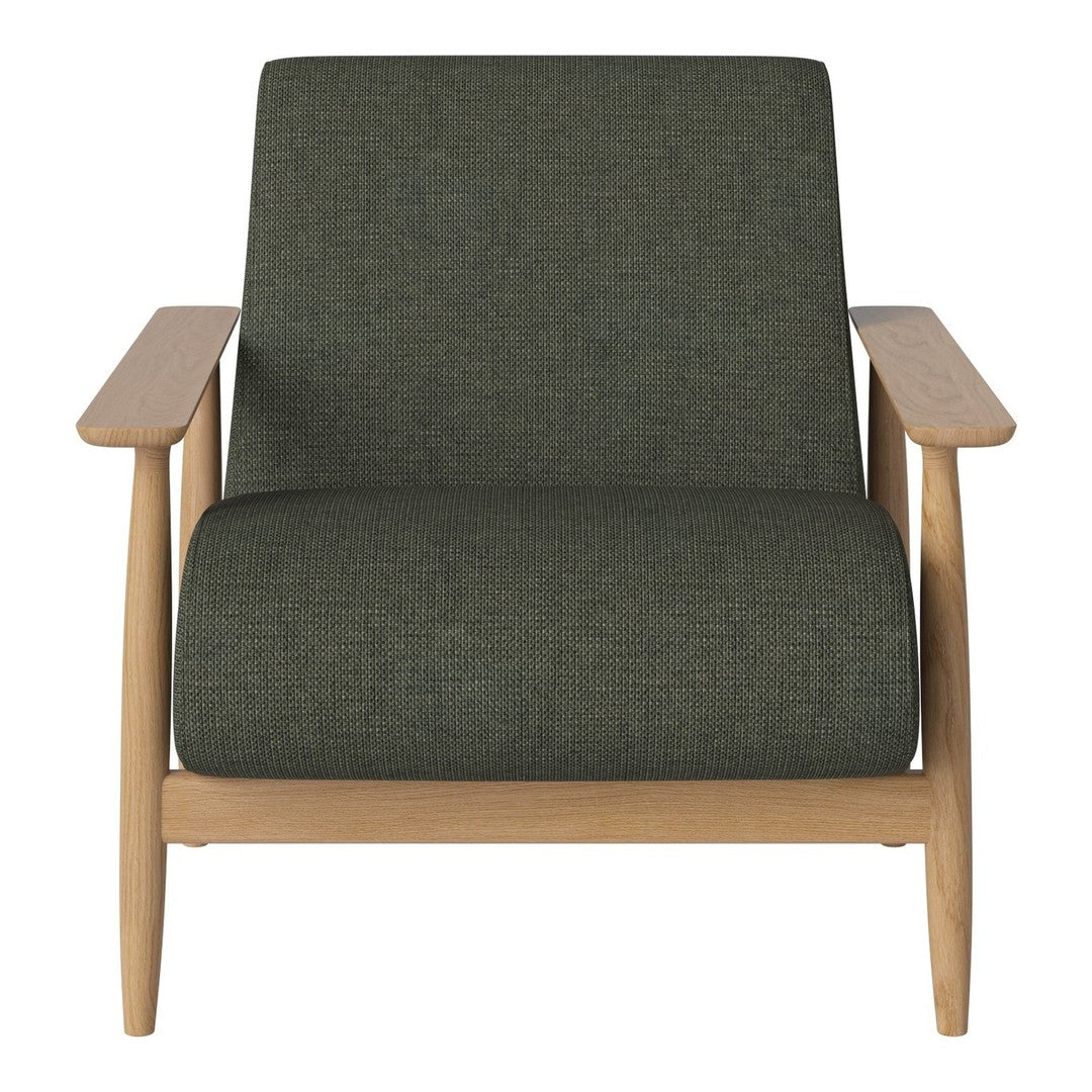 "Green upholstered armchair with a textured pattern and light wood accents."