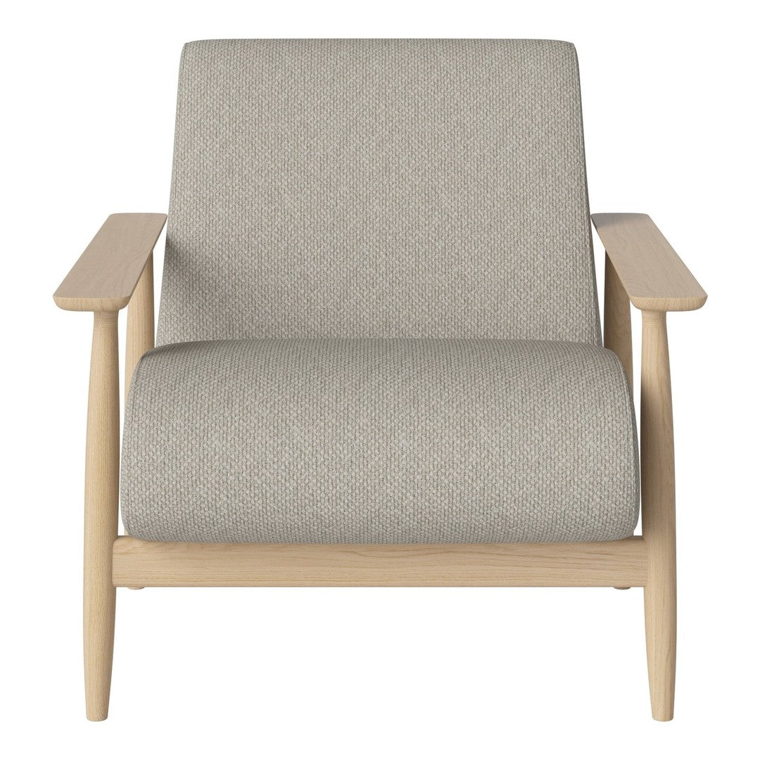 Light gray upholstery on a minimalist chair with natural wood arms, blending modern and cozy aesthetics.