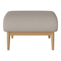 Beige textured ottoman with light wood legs, featuring a subtle pattern for a modern aesthetic.