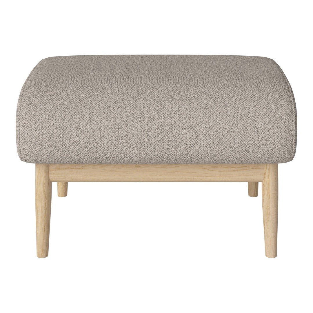Beige textured fabric ottoman with light wood legs, featuring a subtle pattern for a stylish accent.