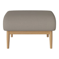 Gray upholstered ottoman with a rounded top and natural wood legs. Simple, modern design ideal for any decor.