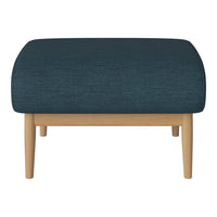 Teal upholstered ottoman with a textured fabric and light wooden legs. Modern and stylish accent for any room.