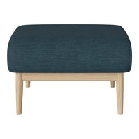 Teal upholstered ottoman with textured fabric, featuring natural wood legs for a modern contrast.