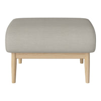 Light gray upholstered ottoman on natural wood legs, featuring a smooth, minimalist design. Perfect for modern interiors.