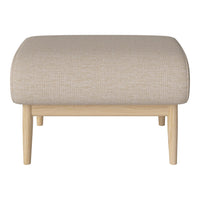 Light beige upholstered ottoman with a textured fabric and natural wood legs, featuring a soft, rounded design.