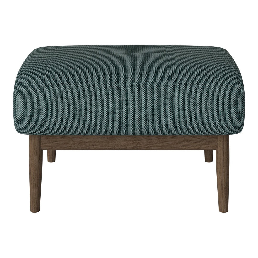 Teal upholstered ottoman with subtle geometric pattern and wooden legs.