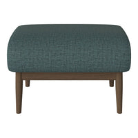 Teal upholstered ottoman with subtle geometric pattern and wooden legs.