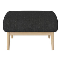 Black textured upholstered ottoman with natural wood legs. Modern design for versatile home decor.