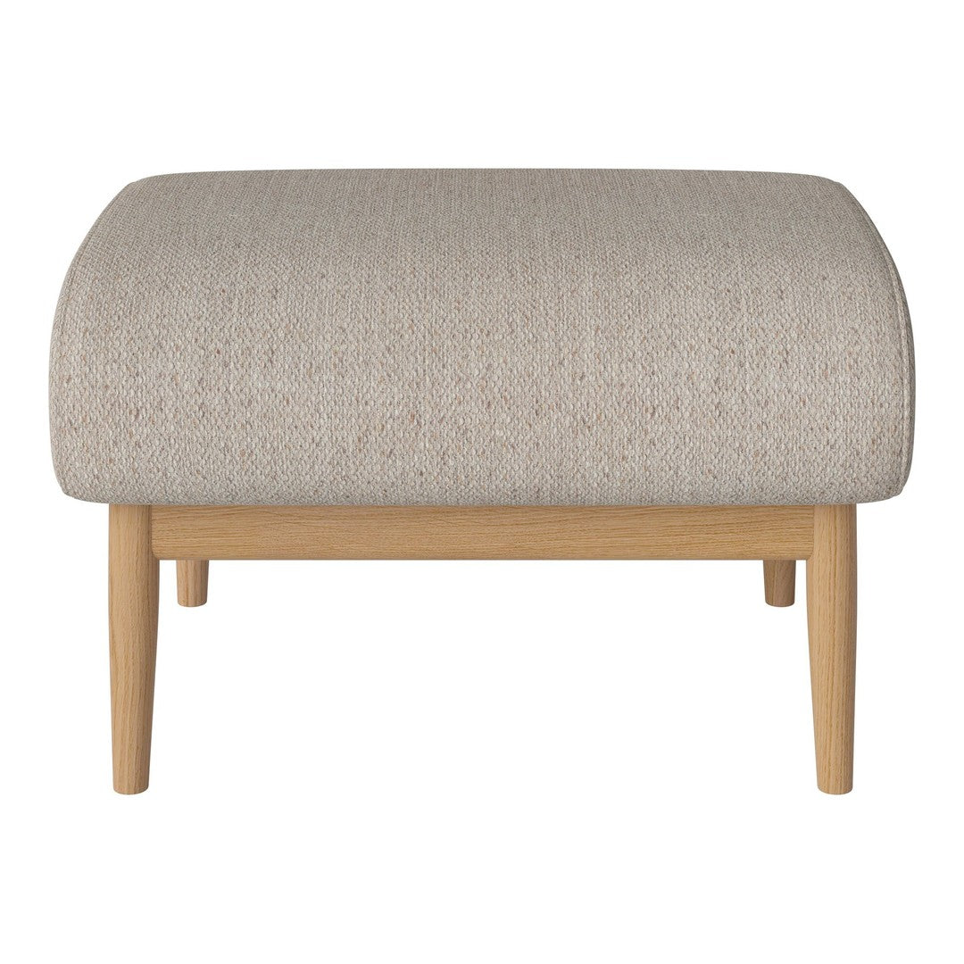Beige textured ottoman with a smooth, rounded top and light wooden legs, perfect for modern decor.