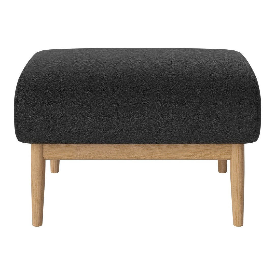 Black upholstered ottoman with a smooth surface and light wooden legs. Minimalist design complements modern decor.