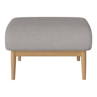Gray upholstered ottoman with a smooth texture and light wooden legs. Minimalist design for modern decor.