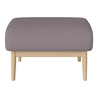 Soft purple upholstered ottoman with curved top and light wood legs, perfect for modern decor.