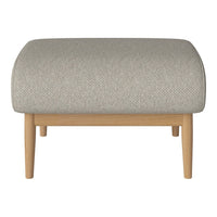 Light gray upholstered ottoman with a subtle textured pattern and natural wood legs. Modern and stylish accent piece.