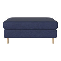 Navy blue upholstered ottoman with a smooth texture and natural wooden legs. Modern minimalist design for stylish interiors.