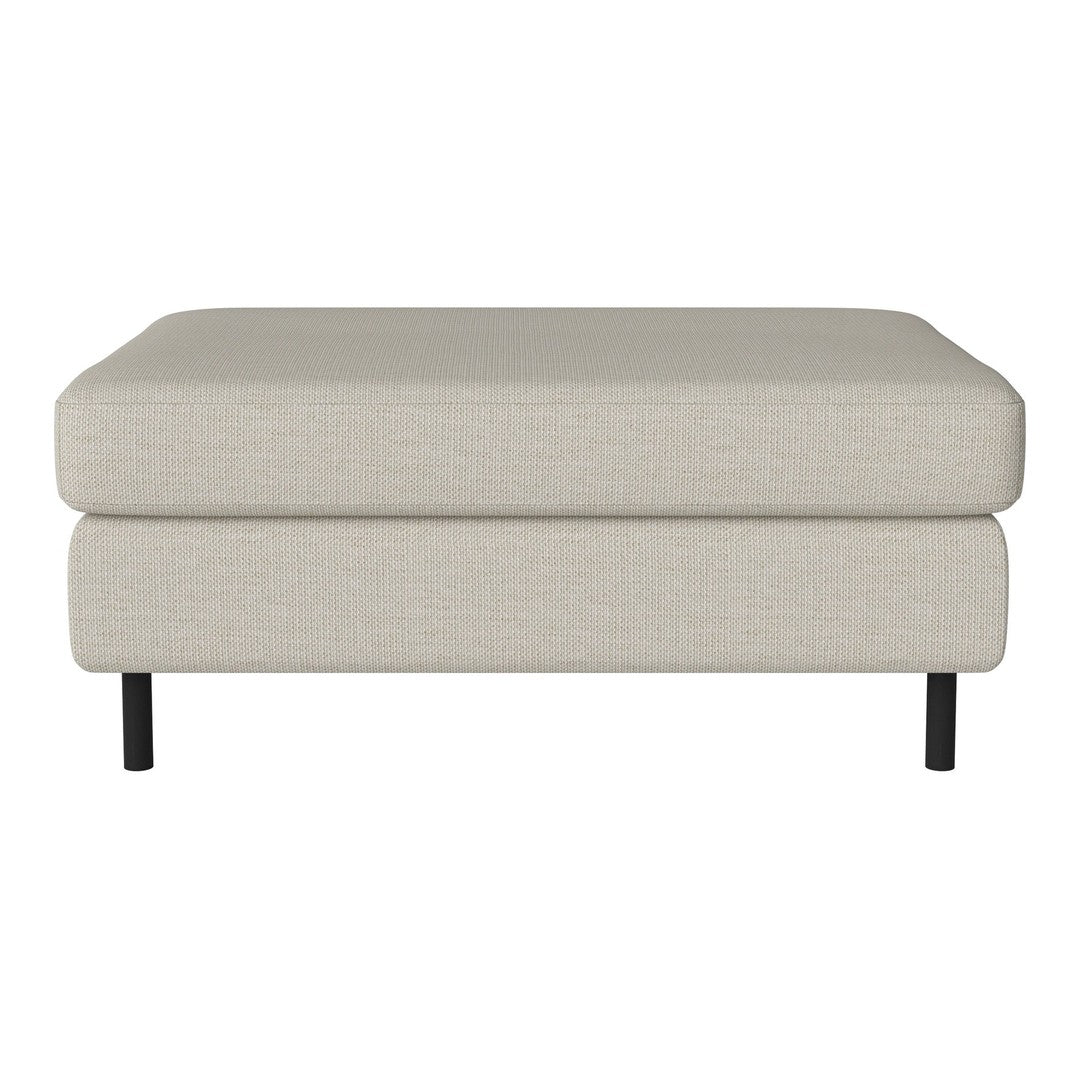 Beige fabric ottoman with clean lines and black legs, perfect for modern living spaces.